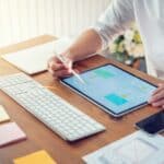 Designer man drawing a website outline and website ux app development on mobile phone.